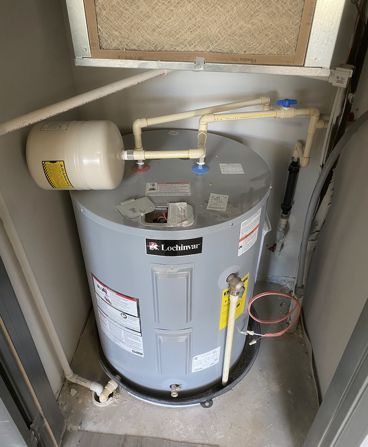 Installed storage water heater with expansion tank and water connections