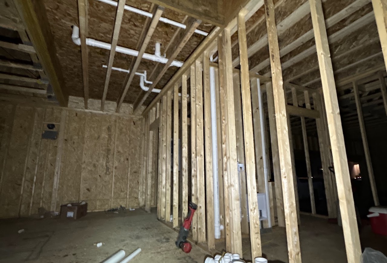 Drain and vent piping installed inside unfinished wood framing