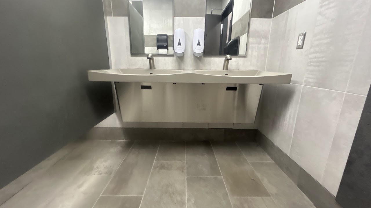 Installed double bowl vanity with self sensing faucet in this remodeled gas station bathroom